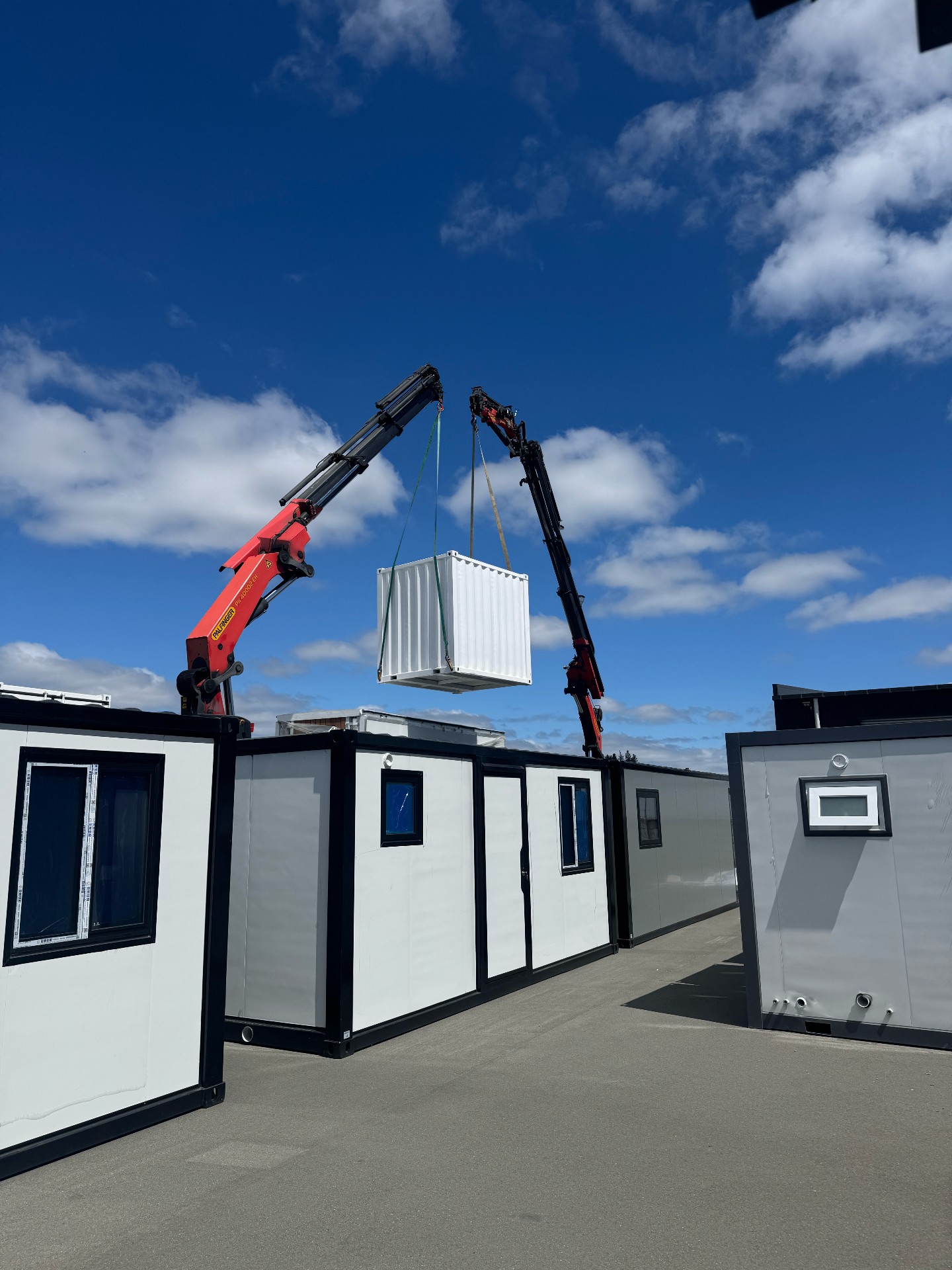 Mini container being craned into position